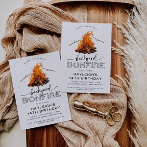 May include: Two white invitation cards with a campfire illustration and the text "backyard bonfire" to celebrate Hayleigh's 14th birthday. The cards include the date, time, location, and RSVP information.
