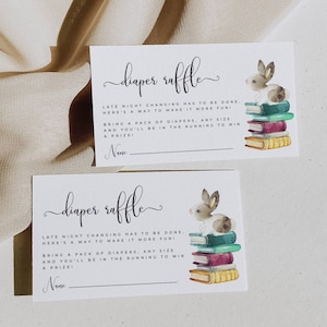 May include: Two white cards with a cute bunny rabbit illustration and the text "diaper raffle". The text reads "Late night changing has to be done, here's a way to make it more fun! Bring a pack of diapers, any size and you'll be in the running to win a prize!" with a blank line for a name.
