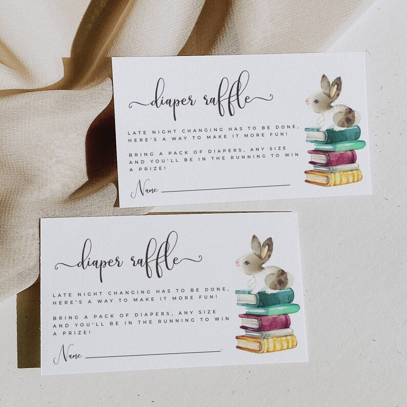 May include: Two white cards with a cute bunny rabbit illustration and the text "diaper raffle". The text reads "Late night changing has to be done, here's a way to make it more fun! Bring a pack of diapers, any size and you'll be in the running to win a prize!" with a blank line for a name.