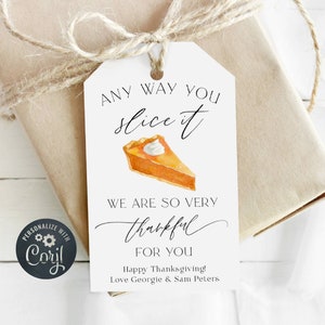 May include: White gift tag with a handwritten message that says "Any way you slice it, we are so very thankful for you." The tag also features a watercolor illustration of a slice of pumpkin pie with whipped cream. The text "Happy Thanksgiving! Love Georgie & Sam Peters" is printed at the bottom of the tag.