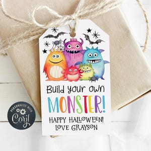 May include: A white gift tag with colorful cartoon monsters. The tag says "Build your own MONSTER! Happy Halloween! Love Grayson".