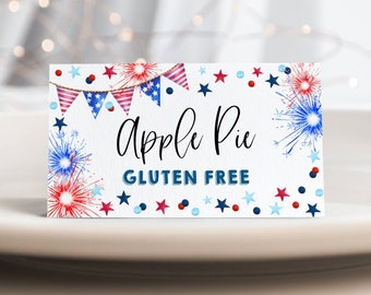 May include: A white sign with red, white, and blue stars and fireworks. The sign says "Apple Pie Gluten Free".