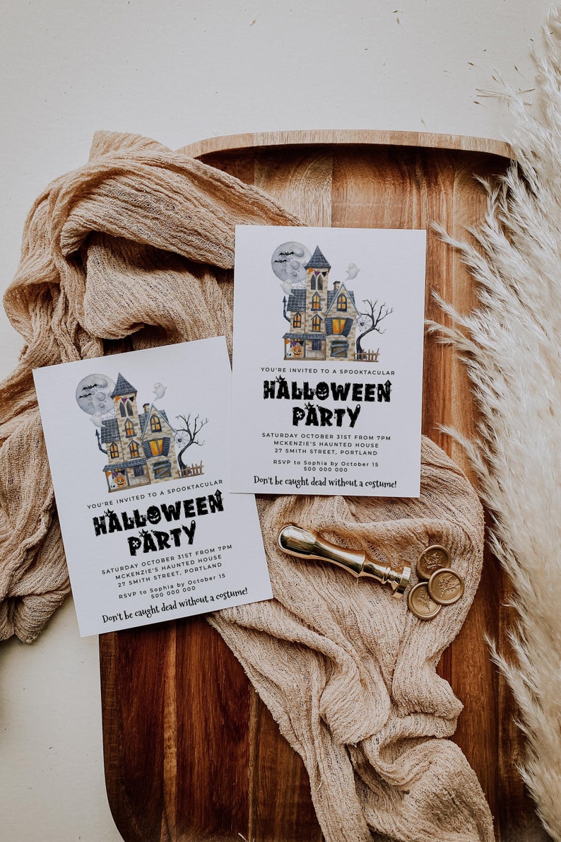 May include: Two white invitation cards with black text and a cartoon illustration of a haunted house. The text reads "You're invited to a Spooktacular Halloween Party" and includes the date, time, location, and RSVP information. The text also says "Don't be caught dead without a costume!"