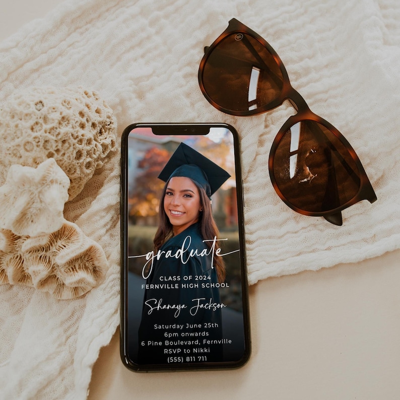 May include: A black and white graduation invitation with a photo of a woman in a cap and gown. The text reads "graduate, Class of 2024, Fernville High School, Shanaya Jackson, Saturday June 25th, 6pm onwards, 6 Pine Boulevard, Fernville, RSVP to Nikki, (555) 811 711".