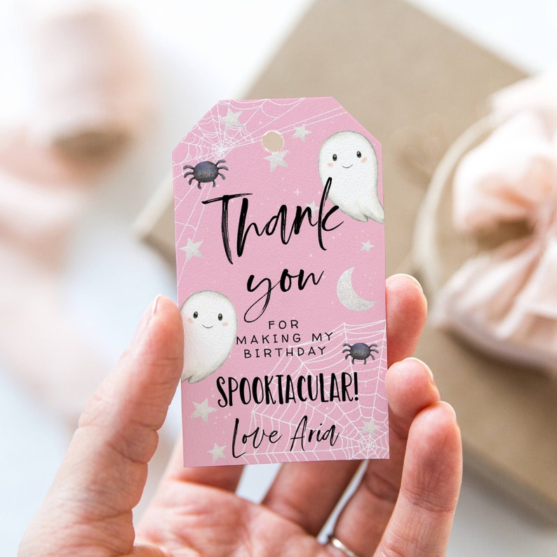 May include: Pink thank you tag with a ghost and spider design. The text reads "Thank you for making my birthday spooktacular! Love Aria."