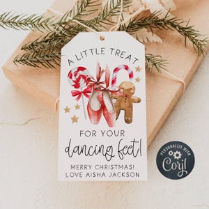 May include: A gift tag with the text "A LITTLE TREAT FOR YOUR dancing feet!" features illustrations of ballet shoes, candy canes, a gingerbread man, and stars. The tag also includes the text "MERRY CHRISTMAS! LOVE AISHA JACKSON."