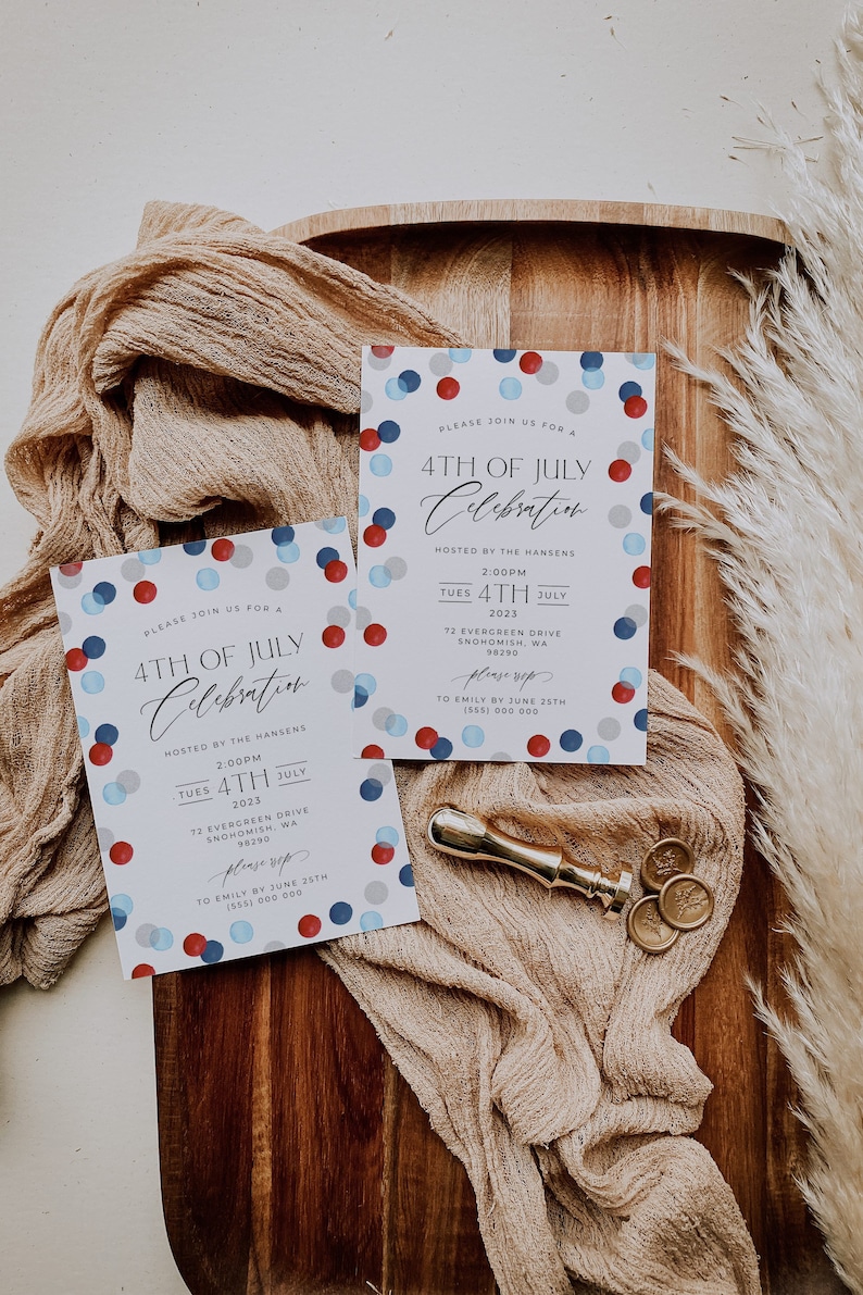 May include: Two invitations for a 4th of July celebration with red, white, and blue confetti. The invitations are on a wooden tray with a gold wax seal and beige fabric.