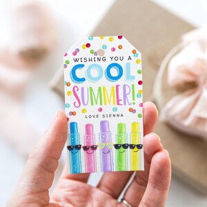 May include: A white gift tag with the text "Wishing You a Cool Summer!" in colorful letters and confetti. Below the text are five colorful popsicle illustrations wearing sunglasses. The tag is personalized with "Love Sienna".