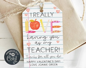 May include: A printable teacher appreciation gift tag with a colorful design featuring the words "I REALLY LOVE having you as my TEACHER!" with a red apple and crayons forming the letters. The tag also includes the text "Thanks for all you do! HAPPY VALENTINE'S DAY! LOVE JOANIE GREEN."