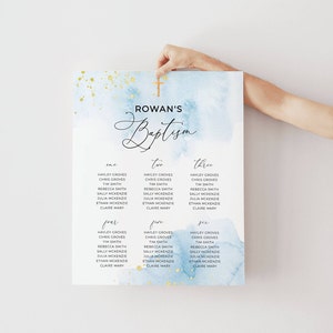 May include: A baptism seating chart with a watercolor background in shades of blue and gold. The chart is labeled "Rowan's Baptism" with guest names listed under the numbers one through six. A wooden cross is at the top.