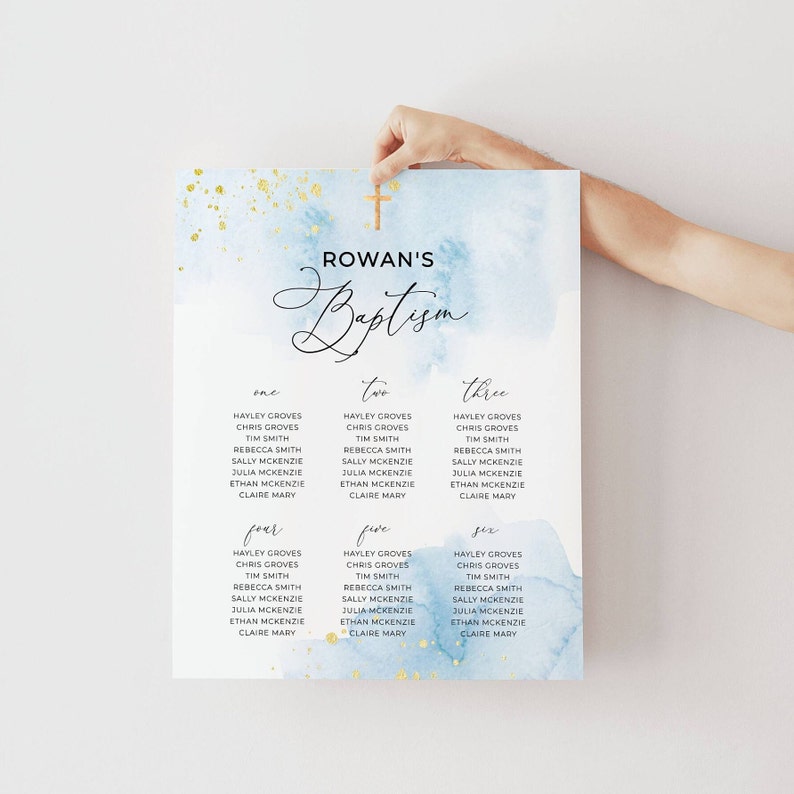 May include: A baptism seating chart with a watercolor background in shades of blue and gold. The chart is labeled "Rowan's Baptism" with guest names listed under the numbers one through six. A wooden cross is at the top.