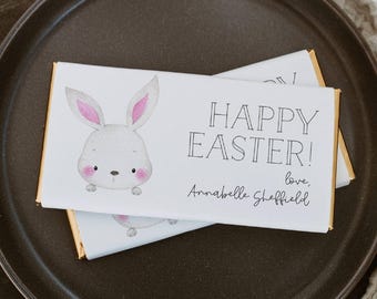 May include: White chocolate bar with a bunny illustration and the text "Happy Easter!" with a signature below.
