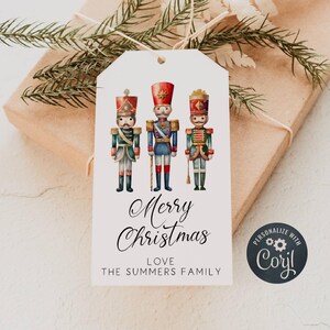May include: A white gift tag with three vintage toy soldier illustrations. The soldiers are wearing red, blue, and green uniforms. The tag says "Merry Christmas" in cursive and "Love The Summers Family". The tag also has a round sticker that says "Personalize with Corjl".
