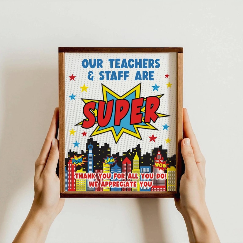 May include: A framed print with a superhero theme. It says "Our teachers & staff are super" with a red and blue comic book style graphic. The bottom of the print says "Thank you for all you do! We appreciate you".