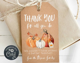 May include: A brown paper gift tag with a watercolor illustration of pumpkins and fall leaves. The text on the tag reads "THANK YOU for all you do We couldn't have picked a better teacher! from the Rouan family".