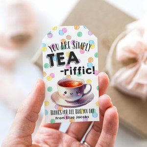 May include: A colorful gift tag with a cartoon teacup and the text "You are simply tea-riffic! Thanks for all that you do! From Eliza Jacobs."