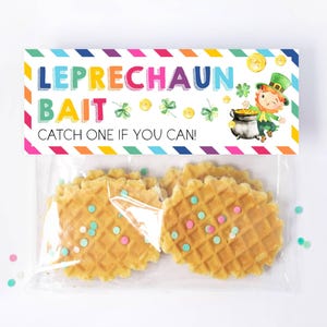 May include: A clear plastic bag with a colorful label that reads "Leprechaun Bait Catch One If You Can!" The bag contains waffle cookies with green and pink sprinkles.
