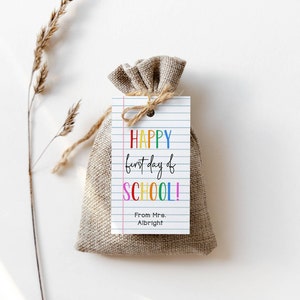 May include: A small burlap bag with a gift tag that says "HAPPY first day of SCHOOL!" in rainbow colors. The tag also says "From Mrs. Albright".