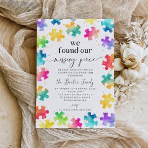 May include: A rectangular white invitation card featuring a border of colourful watercolour puzzle pieces. The text reads: we found our missing piece, PLEASE JOIN US FOR AN ADOPTION CELEBRATION HONORING the Baxter Family, SATURDAY 12 FEBRUARY, 2023.