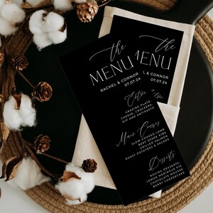 May include: Black and white wedding menu with the text "The Menu" and the names Rachel & Connor and L & Connor with the date 07.07.24. The menu lists appetizers, main courses, and desserts.