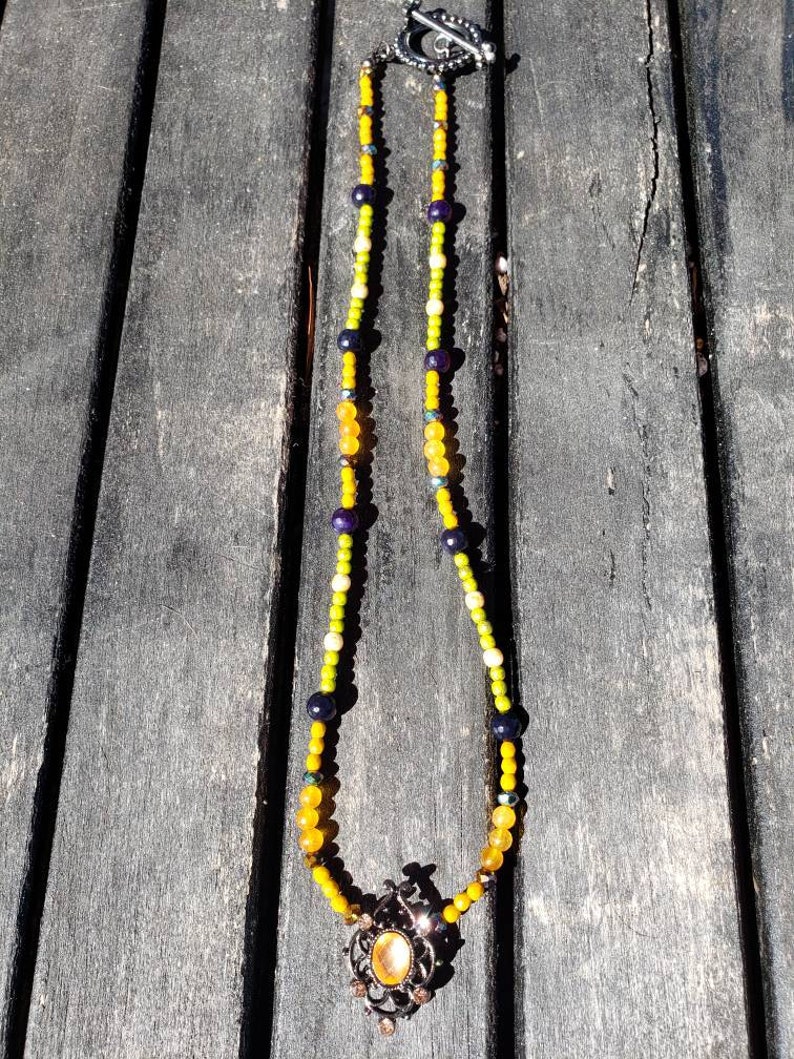 Metal slider with a orange resin cabochon. Spring time orange and green