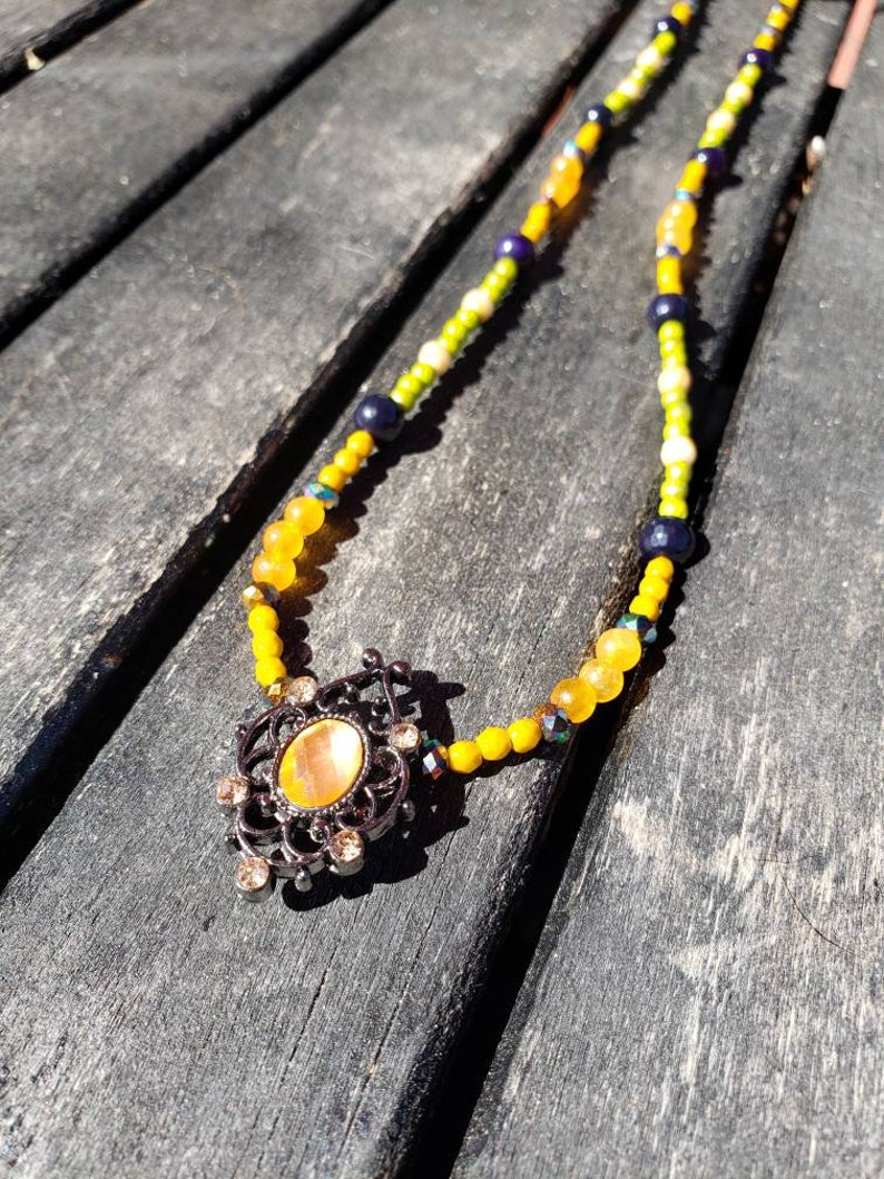 Metal slider with a orange resin cabochon. Spring time orange and green