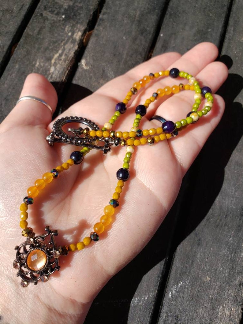 Metal slider with a orange resin cabochon. Spring time orange and green