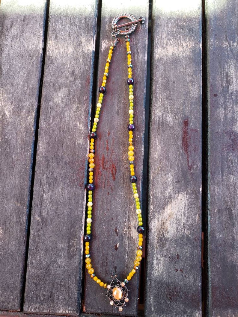 Metal slider with a orange resin cabochon. Spring time orange and green