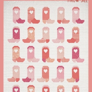 May include: A throw-size quilt with a repeating pattern of pink, peach, and red cowboy boots, each with a heart. The text reads "CUTE TO BOOT" and "THROW SIZE". Finished size is 125.7 cm x 144.8 cm.