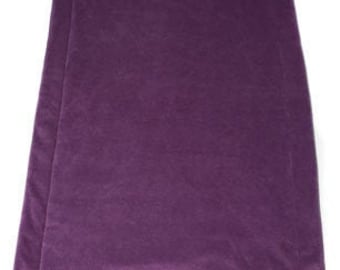 May include: A rectangular, deep purple pet bed with a quilted design. The bed is made of a soft, plush material and is folded in half. The bed is designed for comfort and support for pets.