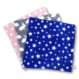 May include: Three fleece pet beds in different patterns. The top bed is blue with white stars, the middle bed is gray with white rabbits, and the bottom bed is pink with white polka dots.
