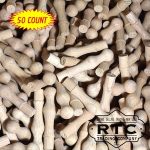May include: A close-up image of a pile of 50 wooden knobs. The knobs are unfinished and have a round shape with a small hole in the center. The knobs are perfect for adding a rustic touch to furniture or crafts.