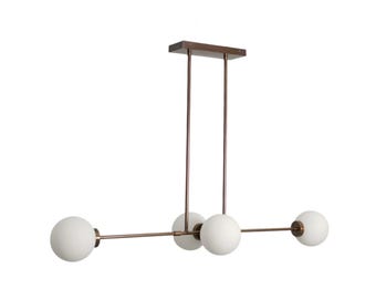 May include: Modern linear chandelier with four frosted white globe shades. The fixture has a rectangular bronze-colored canopy and thin, straight rods and arms. The overall design is minimalist and suitable for various interior styles.