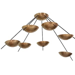 May include: A modern brass chandelier with eight bowl-shaped shades suspended from a central point by black metal rods.