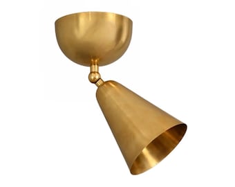 May include: A brass-colored, cone-shaped spotlight fixture. The fixture has a rounded, bowl-shaped base and a cone-shaped light. The light is angled downward, and the fixture is made of a shiny, metallic material.