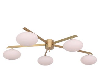 May include: A modern ceiling light fixture with five white, oval-shaped glass shades. The fixture has a brass finish and a starburst design, with each shade extending from a central hub. The light is designed for indoor use.