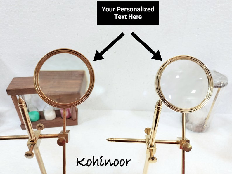 May include: Two gold magnifying glasses on stands, with the text "Your Personalized Text Here" above them. The magnifying glasses are positioned so that the lenses are facing each other. The text "Kohinoor" is visible below the magnifying glasses.