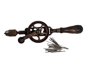 May include: A vintage hand drill with a wooden handle and a metal gear. The drill comes with a set of drill bits.