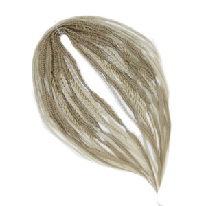 May include: A set of blonde and light brown synthetic hair extensions in a variety of braided styles.
