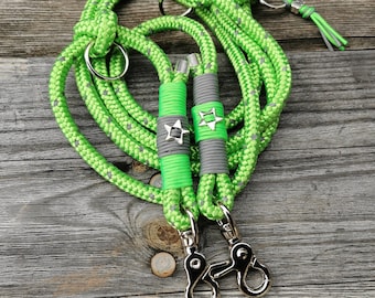 May include: Two green rope dog leashes with silver star accents and silver clips.