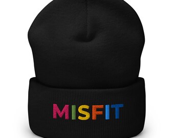 May include: Black beanie with the word "MISFIT" embroidered in colorful letters across the front. The beanie is made of a soft, knitted material and is designed to be worn on the head. The beanie is a stylish accessory.