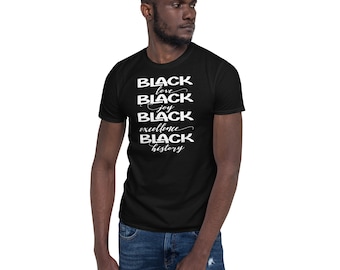 May include: Black crew neck t-shirt with white text. The text includes the words "Black Love, Black Joy, Black Excellence, Black History". The shirt is worn by a person in blue jeans.