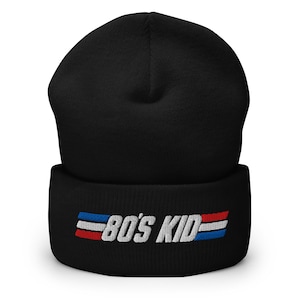 May include: Black beanie with a white embroidered logo that says "80's Kid" with red and blue stripes on either side of the text.