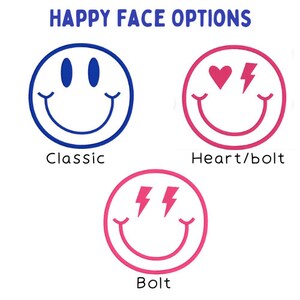 May include: Three smiley face options: a classic yellow smiley face, a pink smiley face with a heart and lightning bolt, and a pink smiley face with two lightning bolts.