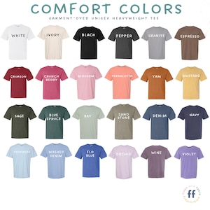May include: A color chart for Comfort Colors garment-dyed heavyweight t-shirts, displaying twenty-four short-sleeve shirts in various colors including white, ivory, black, pepper, granite, espresso, crimson, crunch berry, blossom, terracotta, yam, mustard, sage, blue spruce, bay, sand stone, denim, navy, hydrangea, washed denim, flo blue, orchid, wine, and violet.