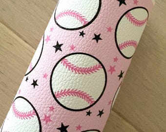 May include: Pink faux leather with a repeating pattern of white baseballs with pink stitching and black stars.