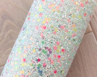 May include: A sheet of light green glitter fabric with iridescent rainbow glitter embedded in the fabric. The glitter is in a confetti pattern.