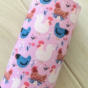 May include: A pink fabric with a repeating pattern of white, brown, and blue chickens with flowers. The fabric has a textured surface.