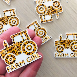 May include: A set of five white, vinyl stickers featuring a tractor design with a leopard print pattern. The stickers say "Farm Girl" in black text.