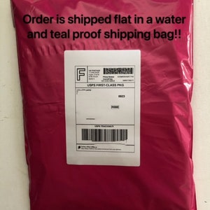 May include: A pink plastic shipping bag with the text "Order is shipped flat in a water and teal proof shipping bag!!" printed on the front. The bag has a white label with the text "USPS FIRST-CLASS PKG" and a tracking number.